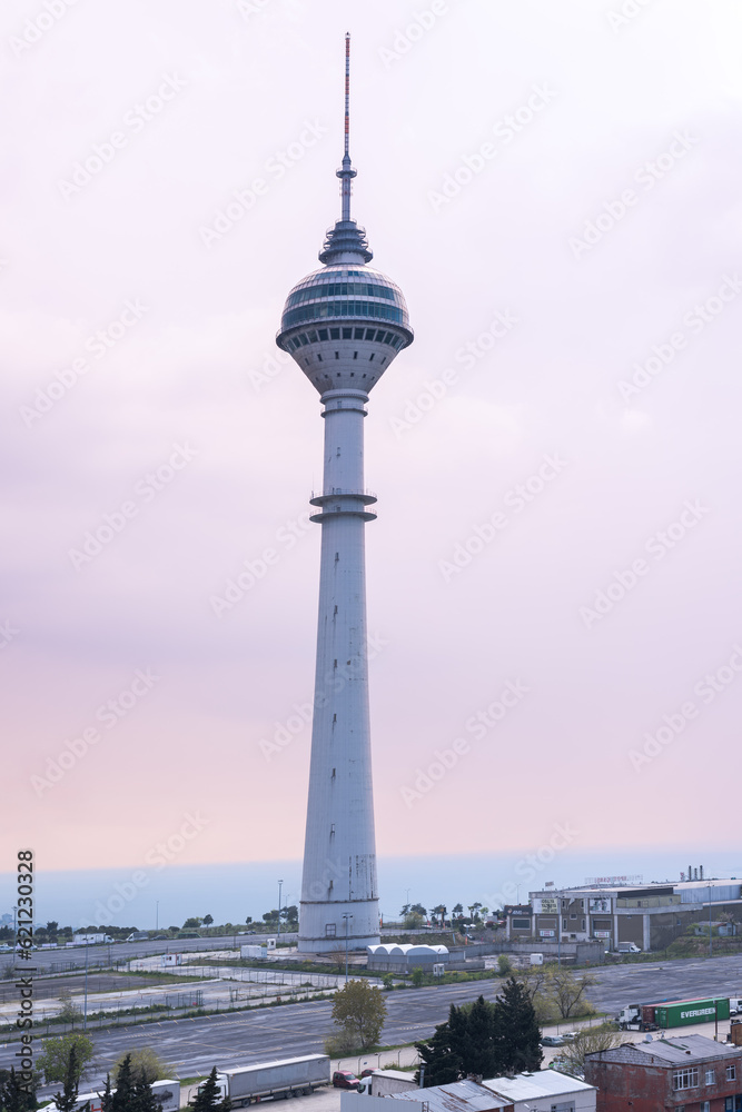 very tall View tower in the middle of the huge parking lot overlooking the city, 360 view, soft sky, dawn
