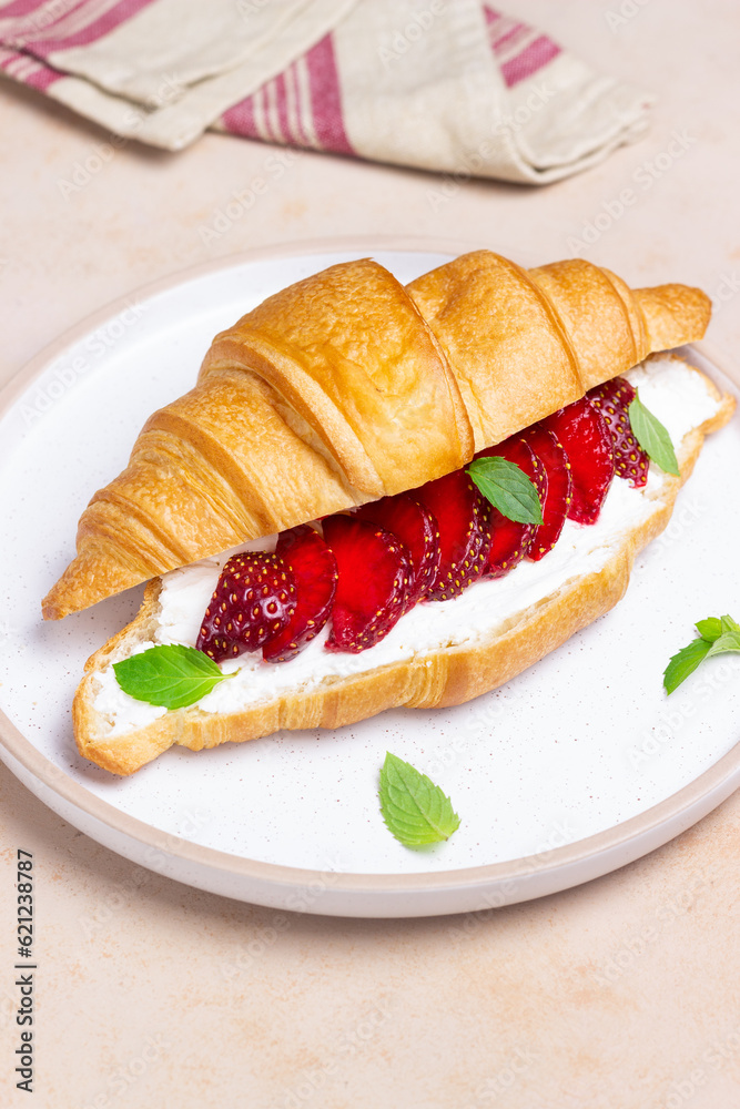 Croissant with strawberries, white cheese and mint. Breakfast. Vegetarian food. Croissant with strawberries, white cheese and mint. Breakfast. Vegetarian food.