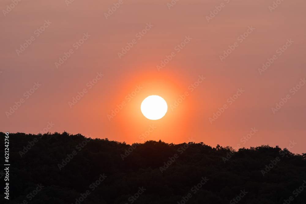 Sunset shot with the sun close to the horizon on a sky filled with sand dust from the Sahara desert Sunset shot with the sun close to the horizon on a sky filled with sand dust from the Sahara desert