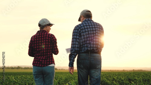 two farmers work tablet sun, farming, teamwork group people, contract handshake agreement, sign brightly sunlight road approaching agriculture successful landscape examining business ground shaking