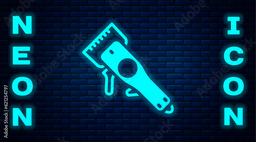 Glowing neon Electrical hair clipper or shaver icon isolated on brick wall background. Barbershop symbol. Vector