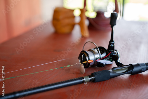 Close-up of a spinning rod on a wooden table