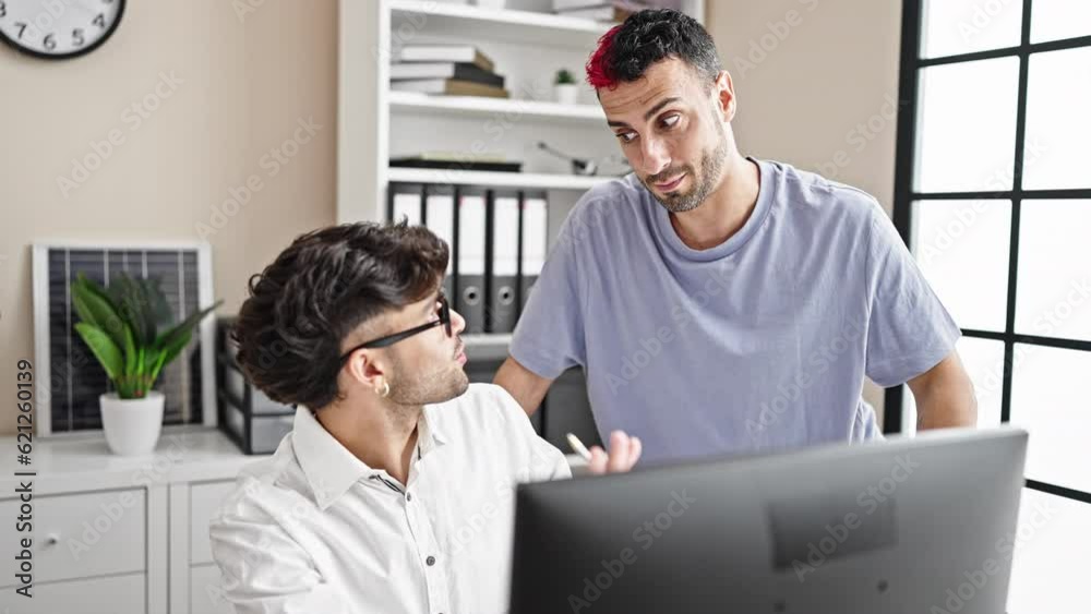 Two men business workers using computer high five at office Two men business workers using computer high five at office
