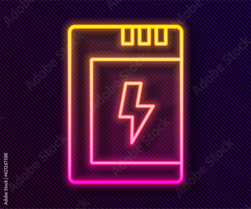 Glowing neon line Battery for camera icon isolated on black background. Lightning bolt symbol. Vector