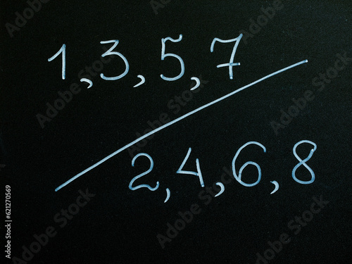 even and odd numbers drawing by chalk on black board background