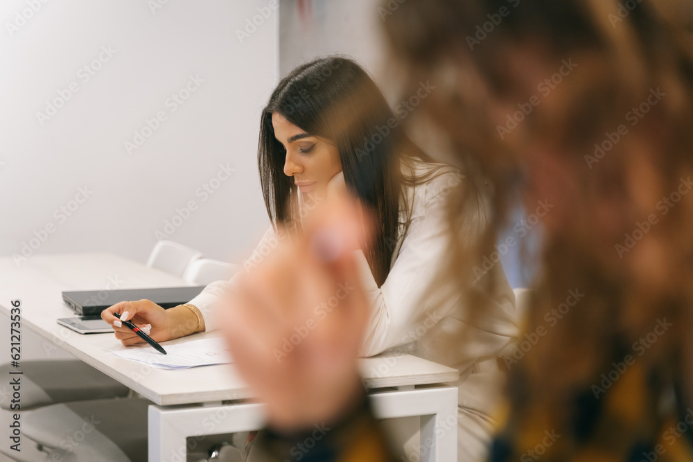 Female student having exam at the classroom Female student having exam at the classroom