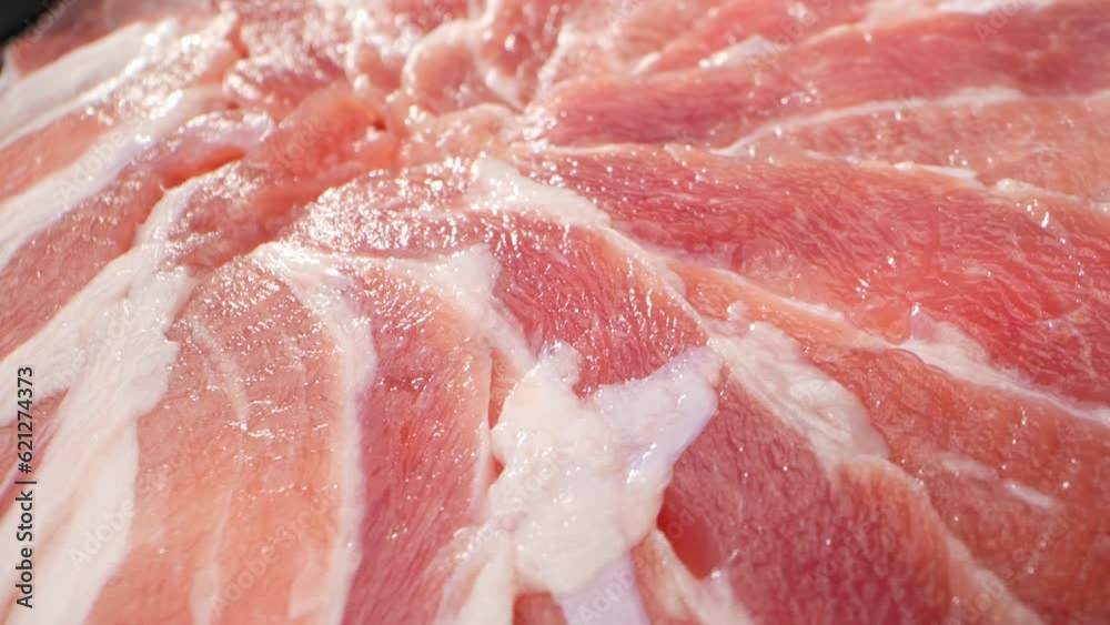 The raw pork belly slice in all its raw, uncooked glory. With streaks of fat running through it. The fat layers are translucent, glistening under the light and showcasing their rich. Food concept. 4K
The raw pork belly slice in all its raw, uncooked glory. With streaks of fat running through it. The fat layers are translucent, glistening under the light and showcasing their rich. Food concept. 4K