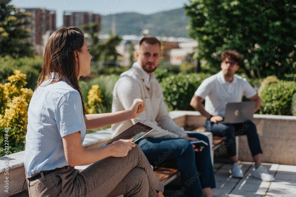 Brunette woman working remotely with her male business partners. Businesswoman explaining new business idea to her male partners Brunette woman working remotely with her male business partners. Businesswoman explaining new business idea to her male partners