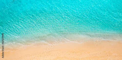Summer seascape beautiful waves, blue sea water in sunny day. Top view coast. Sea aerial drone view, amazing tropical nature peaceful. Beautiful bright sea calm waves splash. Mediterranean beach sand