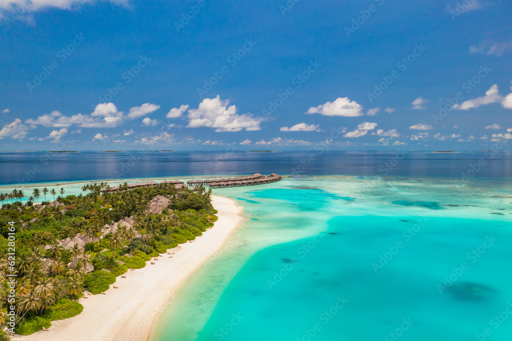 Beautiful amazing Maldives paradise. Fantastic tropical aerial travel landscape, seascape. Luxury water villas bungalows. Dream vacation, best destination aerial drone beach view. Palm trees sea sky