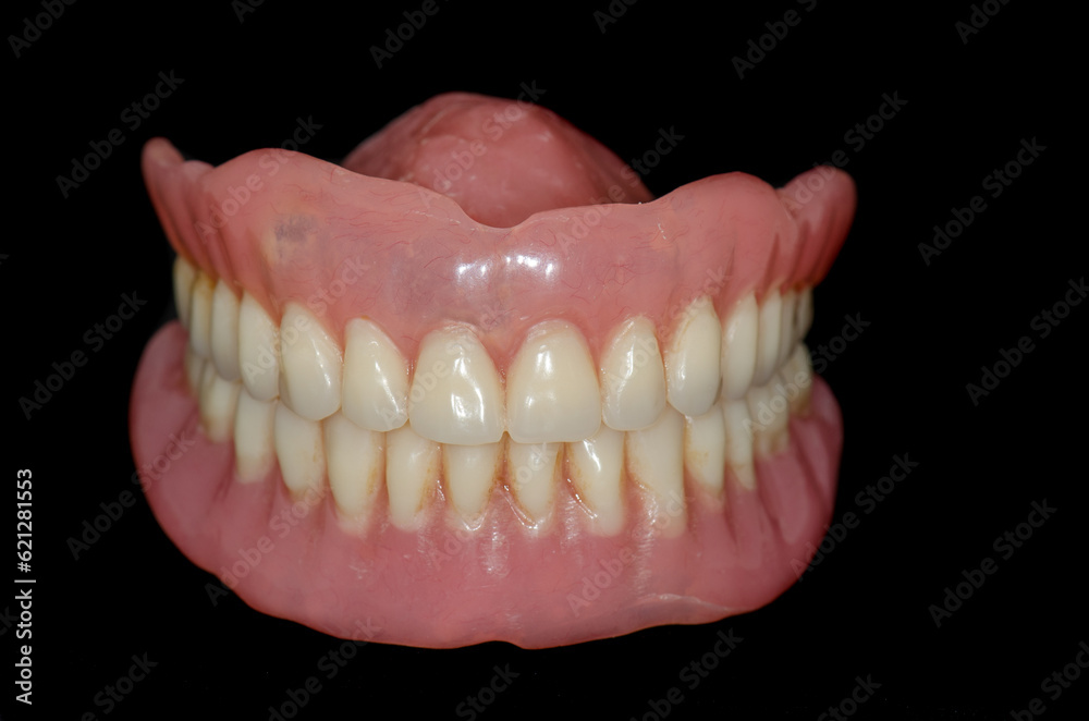 A set of full removable dentures in black background A set of full removable dentures in black background