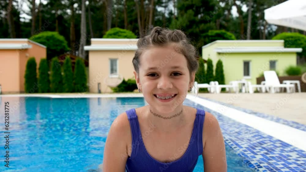 Young girl in the swimming pool, close-up.