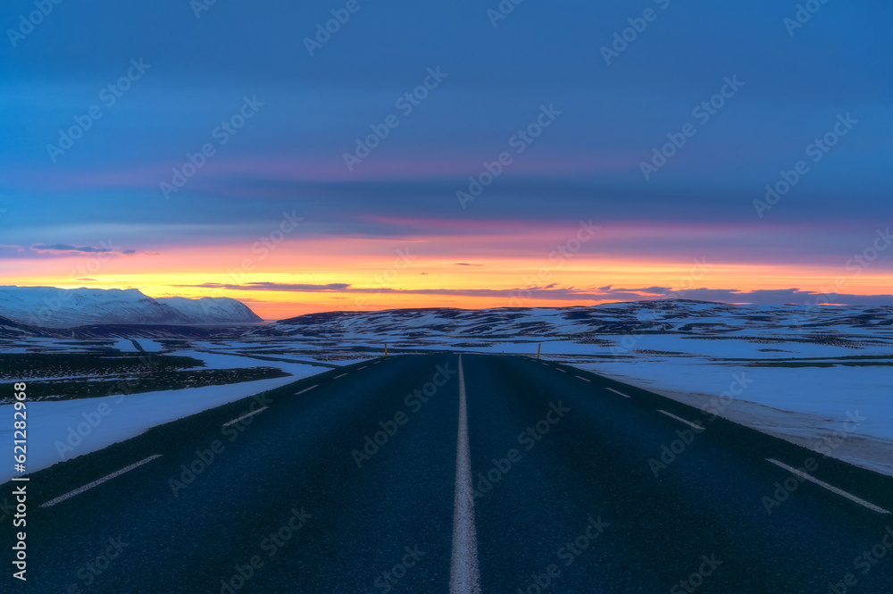 Beautiful sunset in the road with snow in Iceland