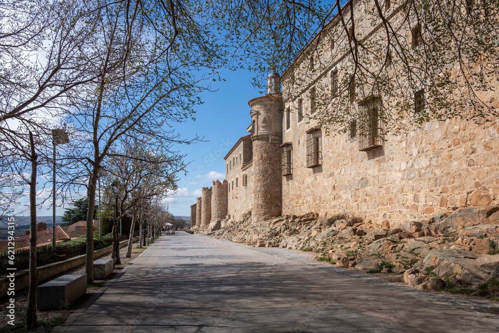 Promenade by Avila Medieval Walls with Episcopal Palace - Avila, Spain Promenade by Avila Medieval Walls with Episcopal Palace - Avila, Spain