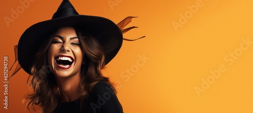 Fotografija Laughing Happy Adult Woman Wearing a Witches Costume for Halloween on an Orange