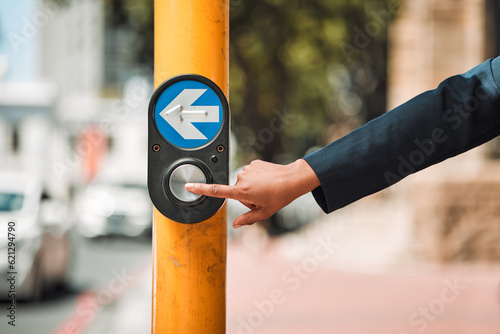 Fototapeta Woman, hands and arrow button on road in city for pedestrian crossing signal in safe travel outdoors