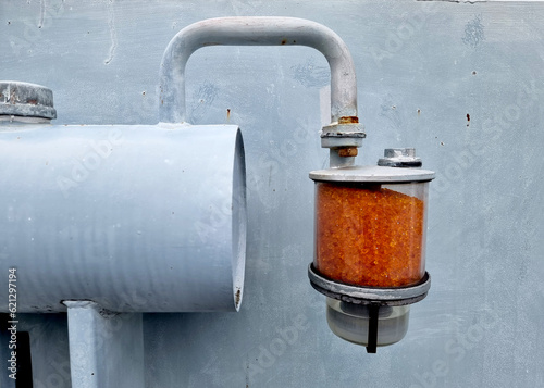 Fotografia Silica Gel Breather contains orange silica gel attach to the conservator tank of the Distribution Transformer