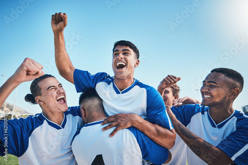 Fototapeta Naklejka Na Ścianę i Meble -  Football player, winner team and people winning in competition, game or sports goals, success and cheers. Yes, wow and excited group of young men with achievement and soccer celebration on blue sky