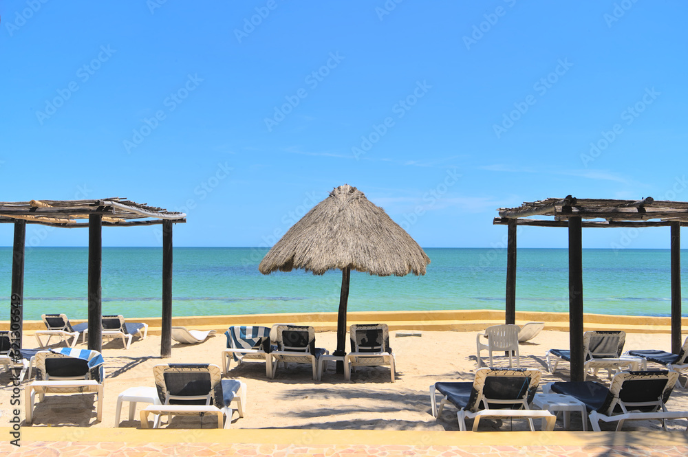 Chairs and parasol on a sand beach and horizon (Merida, Yucatan, Mexico)