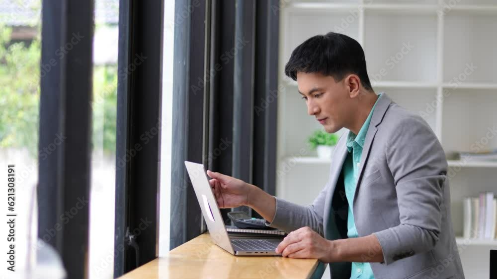 Happy businessman casually working with laptop in office. Happy businessman casually working with laptop in office.