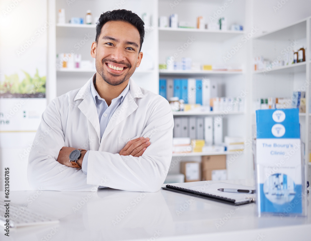 Asian man, portrait and pharmacist with arms crossed in pharmacy, drugstore or shop. Face, confidence or medical professional, happy doctor or worker with a pharmaceutical job for healthcare in Japan