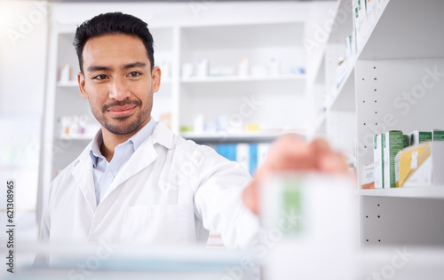 Asian man  pharmacist and medicine for stock check at pharmacy  drugstore or shelf. Medical professional  inventory pills or doctor with pharmaceutical drugs  medication or supplements for healthcare