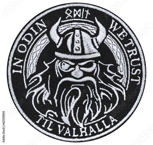 Object photo, isolate. Embroidered patch with the image of the Norse Viking god Odin and the inscription "In Odin we trust". Accessory for rockers, bikers, metalheads and punks.