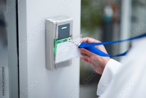 Hand, key card and scan for security door, entrance or access control for safety in business, facility and property. Hands, electronic keys and laser reader or technology to lock or secure laboratory photo