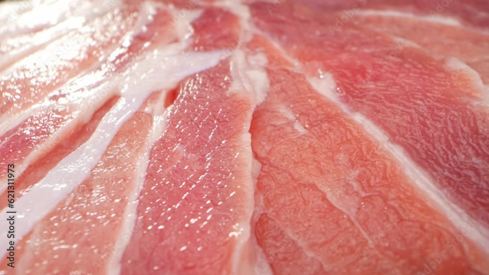 Macro video of raw pork belly slice with a probe lens reveals intricate marbling, tender texture, and juicy fat, tantalizing the senses. Meat industry. Frozen meat concept. Food background. 4K UHD
Macro video of raw pork belly slice with a probe lens reveals intricate marbling, tender texture, and juicy fat, tantalizing the senses. Meat industry. Frozen meat concept. Food background. 4K UHD