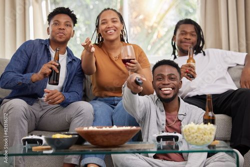 Relax, television and friends on a sofa with beer and popcorn for movie, film or streaming in their home. Group of people, watching tv and smile in living room together with entertainment on weekend