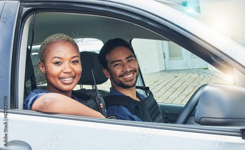 Police, driving together and portrait in car, smile and happy partnership to stop crime with teamwork in city. Black woman, man and patrol street in metro for justice, law and government surveillance © Tamline L/peopleimages.com