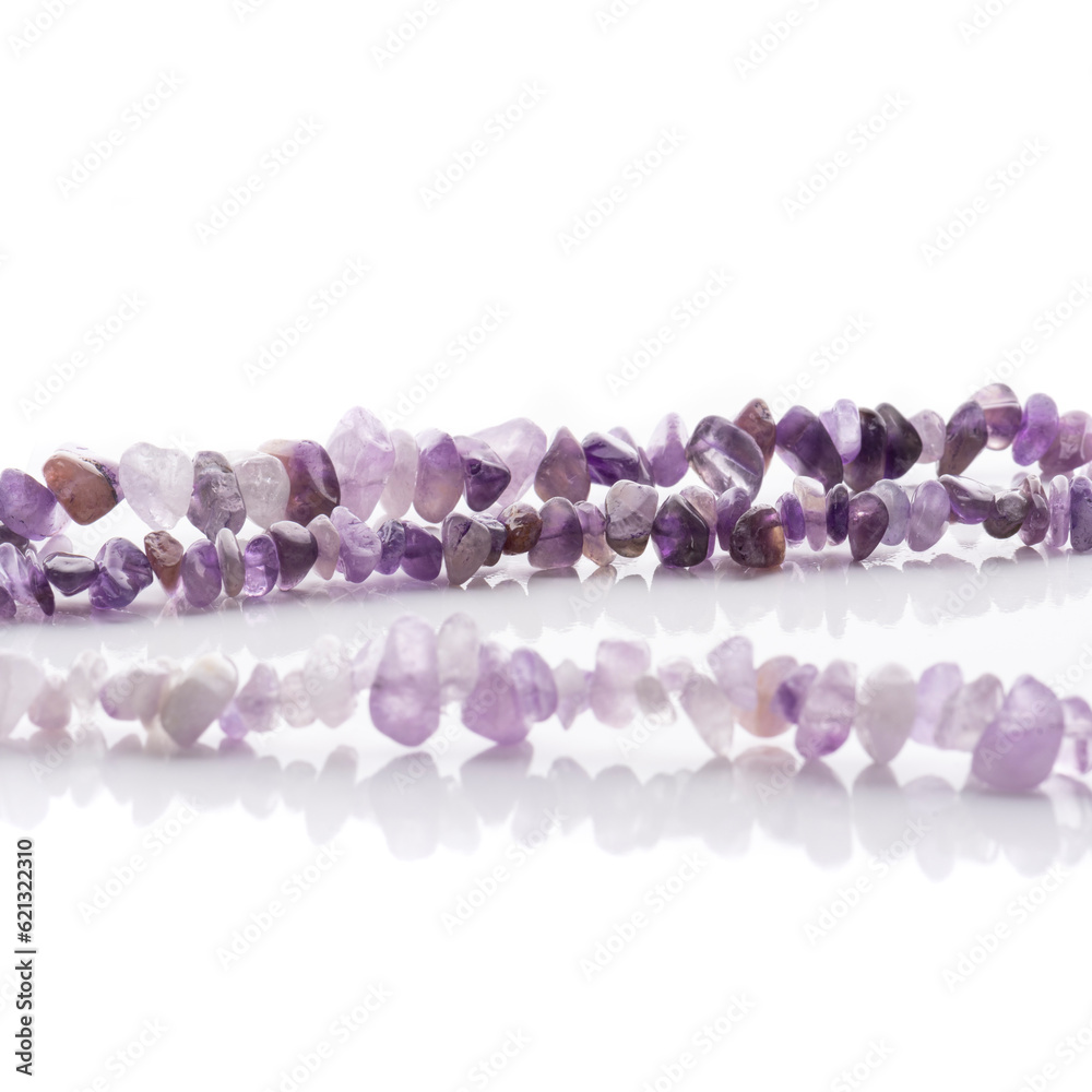 Strung amethyst natural stone strings on white background. Energy crystals. Healing gemstones. Birthstones.