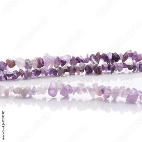 Obraz na płótnie Strung amethyst natural stone strings on white background. Energy crystals. Healing gemstones. Birthstones. w salonie