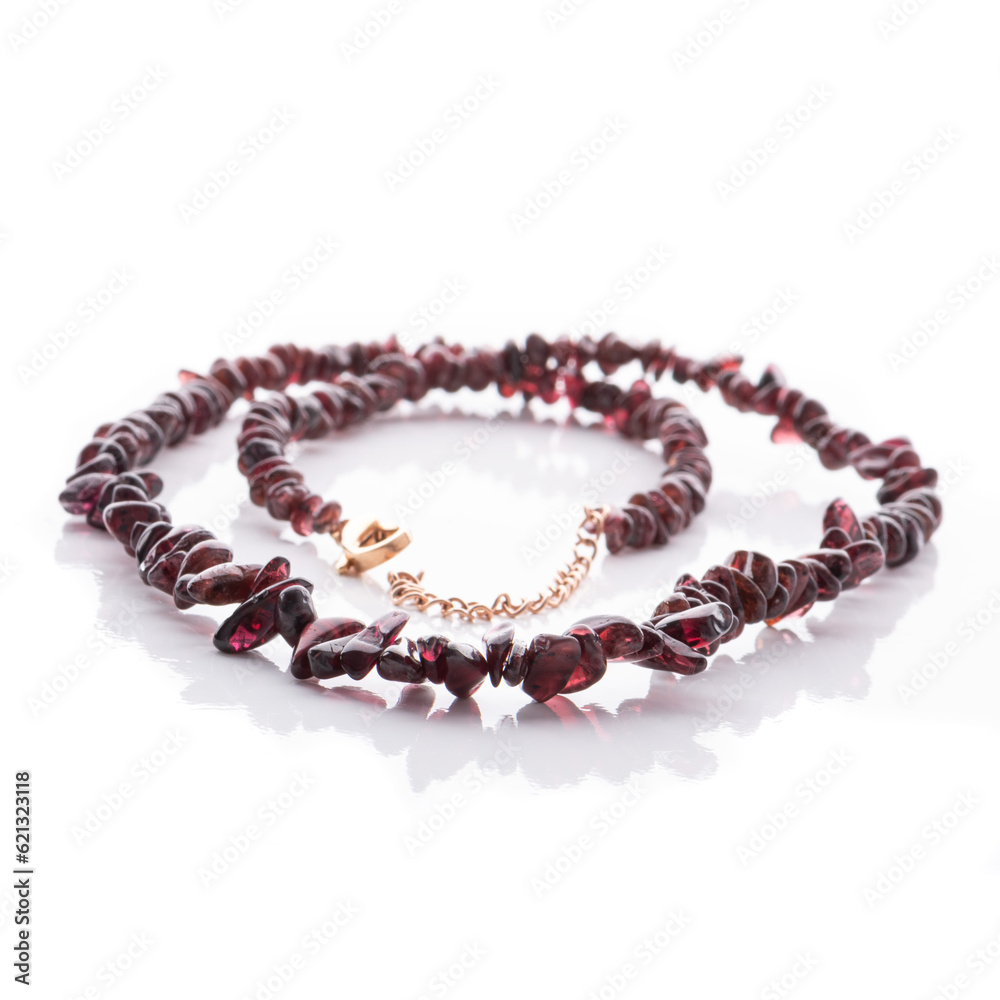 Dark red garnet natural stone necklace on white background. Energy crystals. Healing gemstones. Birthstones.