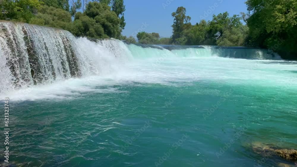 Manavgat waterfall Manavgat River is near the city of Side, 3 km north of Manavgat in Turkey. A wide stream of water falls from a low height. Manavgat waterfall Manavgat River is near the city of Side, 3 km north of Manavgat in Turkey. A wide stream of water falls from a low height.