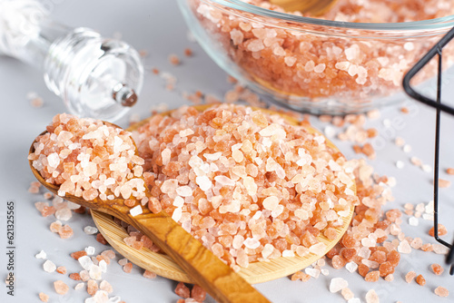 Wallpaper Mural Himalayan pink salt in wooden spoon, salt grinder and glass jars poured over rustic kitchen tabletops, cooking using pink Himalayan salt. Torontodigital.ca