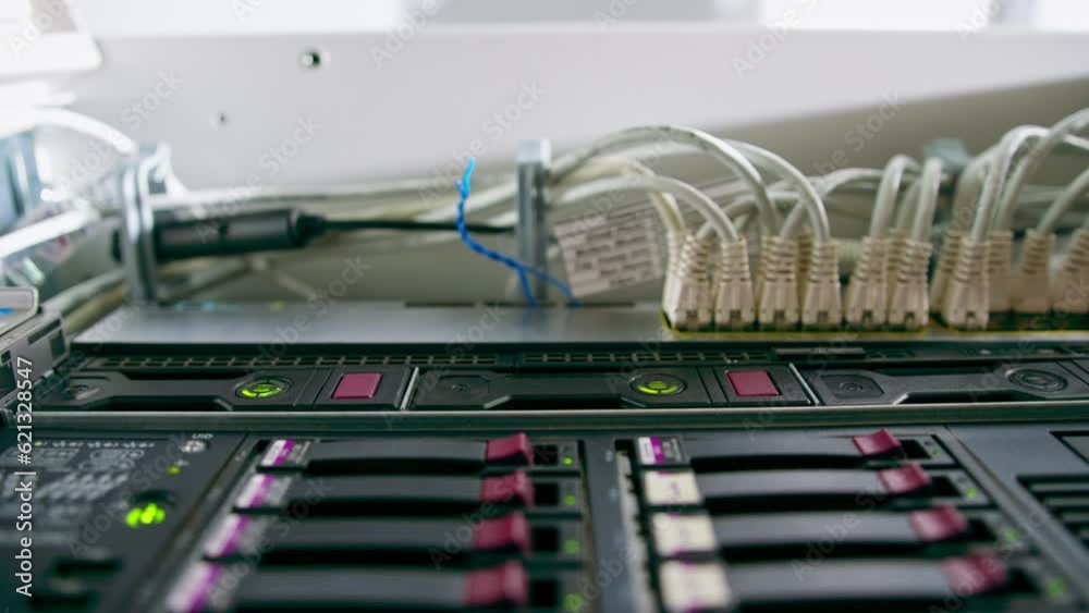 a bunch of patch network cables sorted in a rack cabinet leading from a ...