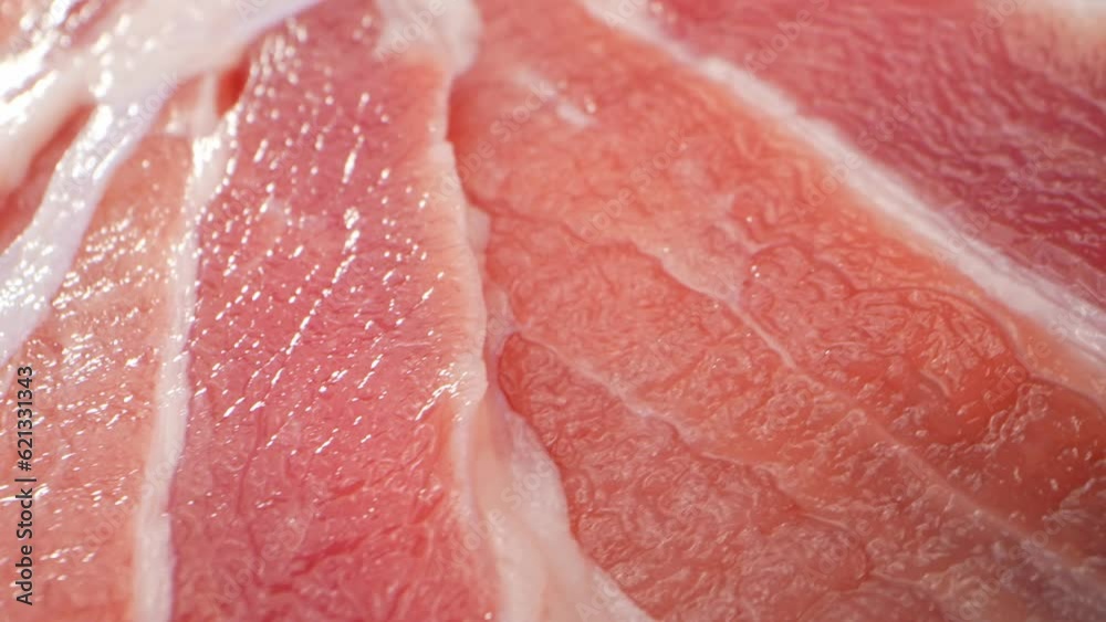 A macro video with a probe lens provides an up-close and detailed look at a raw pork belly slice, capturing its intricate textures, marbling, and the contrasting nature of the meat and fat. 4K UHD
A macro video with a probe lens provides an up-close and detailed look at a raw pork belly slice, capturing its intricate textures, marbling, and the contrasting nature of the meat and fat. 4K UHD