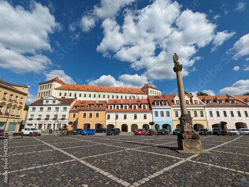Bilina historical city center with fountains and cobble stone square, churches and castle above the old town