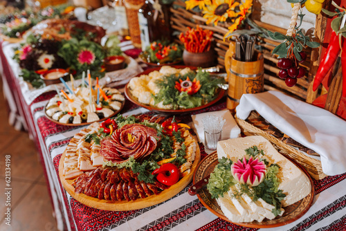 Cossack table in the best restaurants. Festive table at the wedding. National Ukrainian cuisine. Fat  sausages  alcohol. Catering.