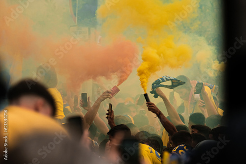 Colored smoke dye being grabbed by people on the streets,  supporters crowd celebrating before a football match. UD Las Palmas Club, La liga