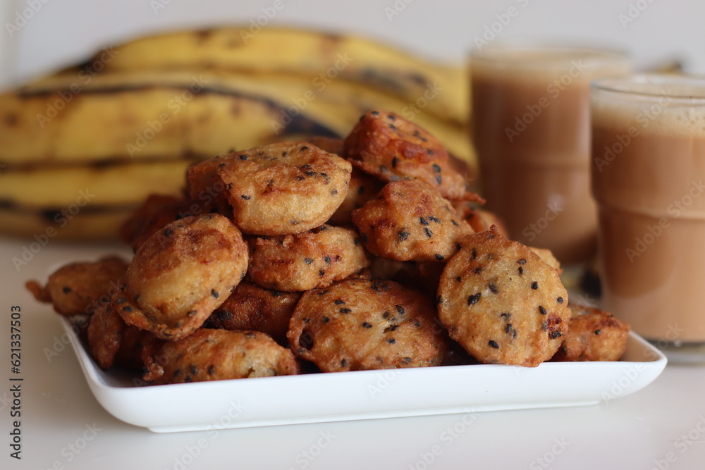 Bite sized plantain fritters. Ripe plantain disk dipped in a batter of whole wheat flour and sesame seeds and deep fried