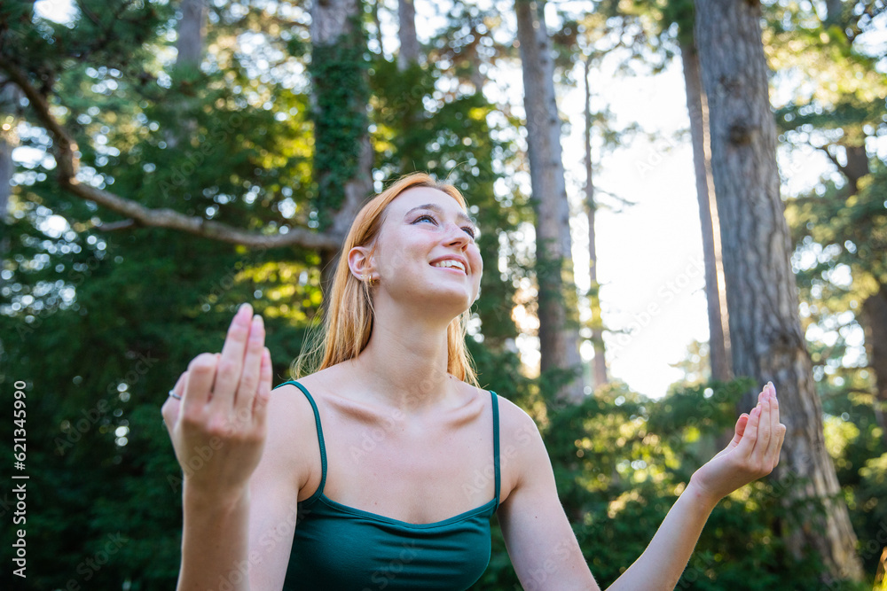 A young woman during a meditation exercise while doing yoga, outdoor portrait A young woman during a meditation exercise while doing yoga, outdoor portrait