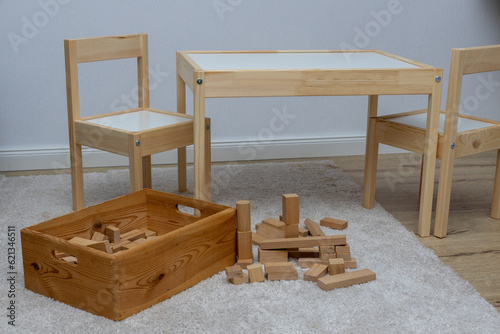 Stylish child table and chair. White and wooden colors