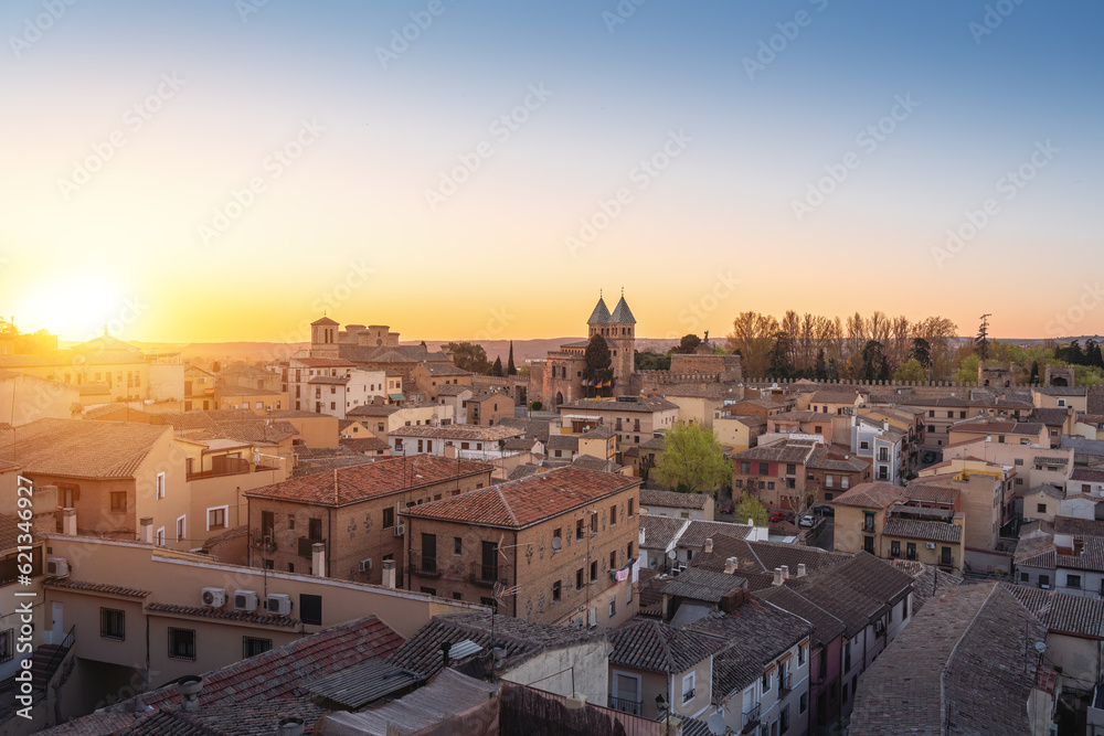 Toledo Skyline at sunset with Puerta de Bisagra Nueva Gate and Church of Santiago del Arrabal - Toledo, Spain
