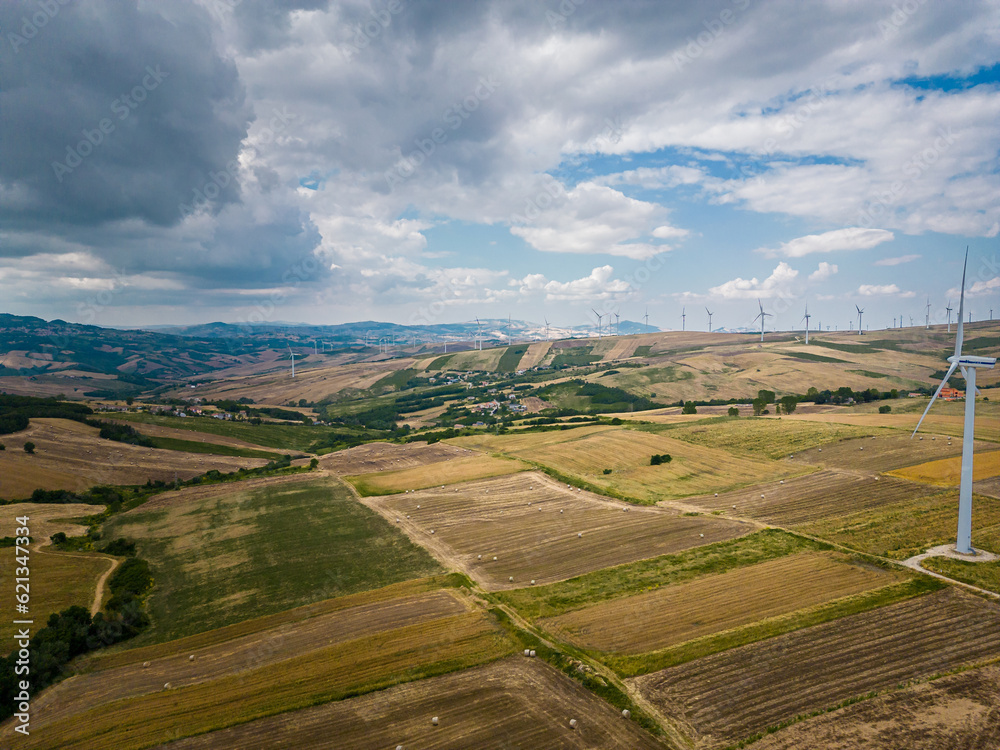 aerial view of a wind farm in Campania. The wind turbines are immersed in cultivated agricultural fields