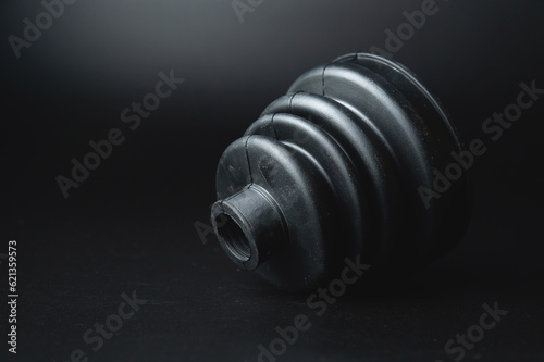 New car parts. Car wheel joint boot, CV joint rubber boot, on a black background