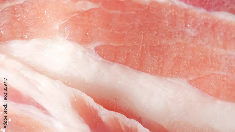 Raw pork belly slice, The camera moves across the slice, you may notice the contrasting textures between the meat and the fat. The meat appears firmer and more compact, while the fat is softer. 4K
Raw pork belly slice, The camera moves across the slice, you may notice the contrasting textures between the meat and the fat. The meat appears firmer and more compact, while the fat is softer. 4K