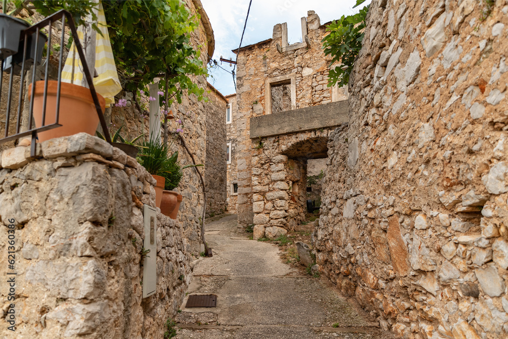 Stone houses and bell tower of the village Velo Grablje on Island Hvar in Croatia, founded in the 14th century. 