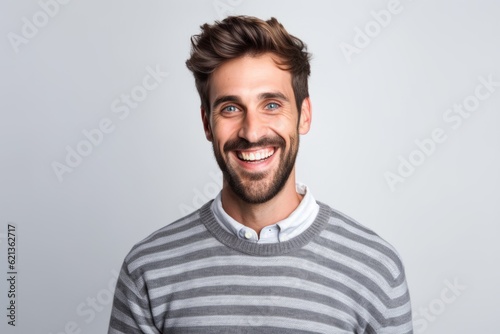Portrait of a handsome young man laughing isolated on a white background © Nerea